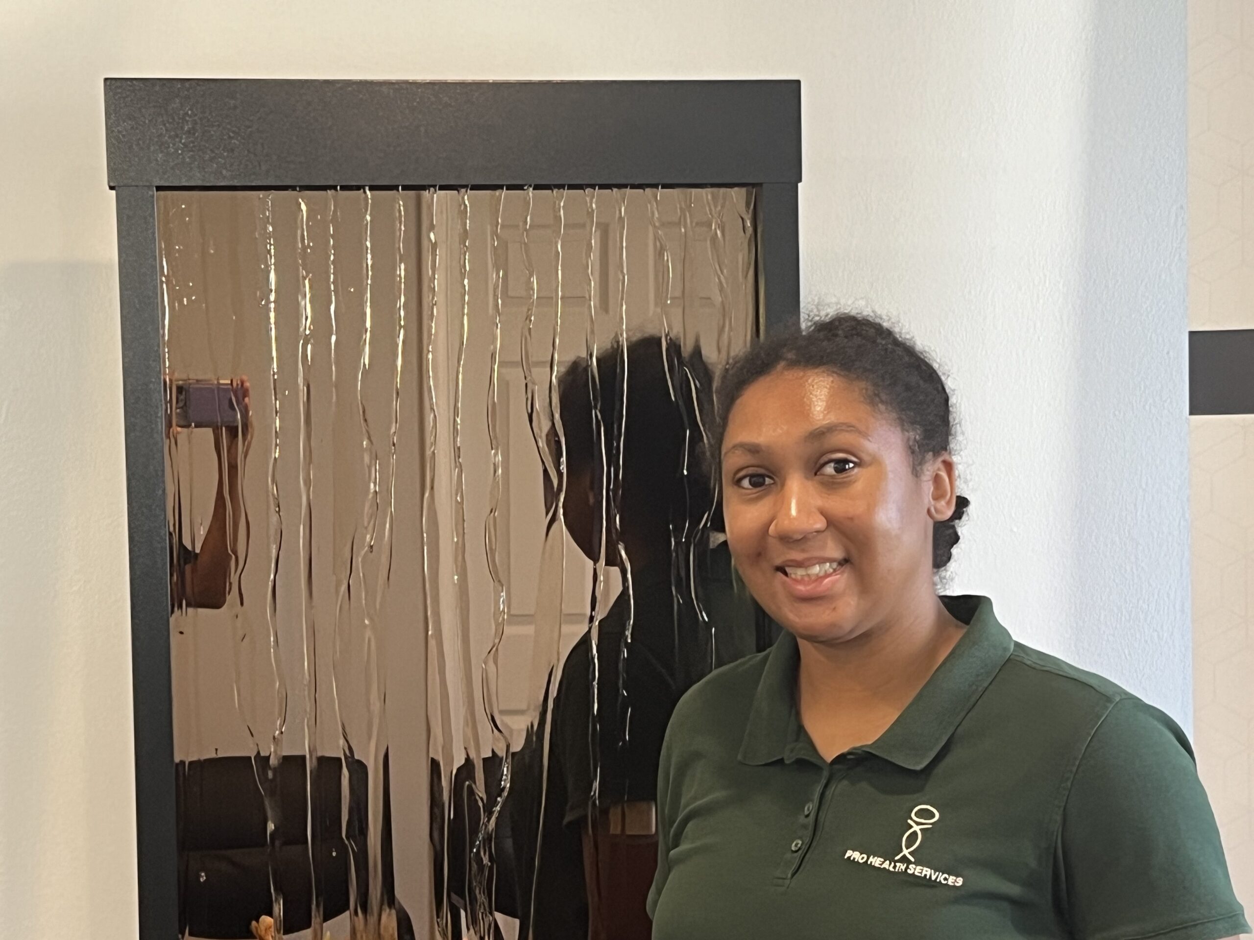 Pro Health Services Registered Dietitian Nutritionist, Grace, smiling and wearing a gree Pro Health Services blouse