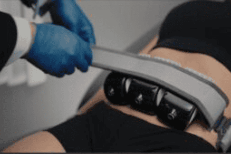 Woman laying on table in 2 piece black athletic short set and a skin tightening belt